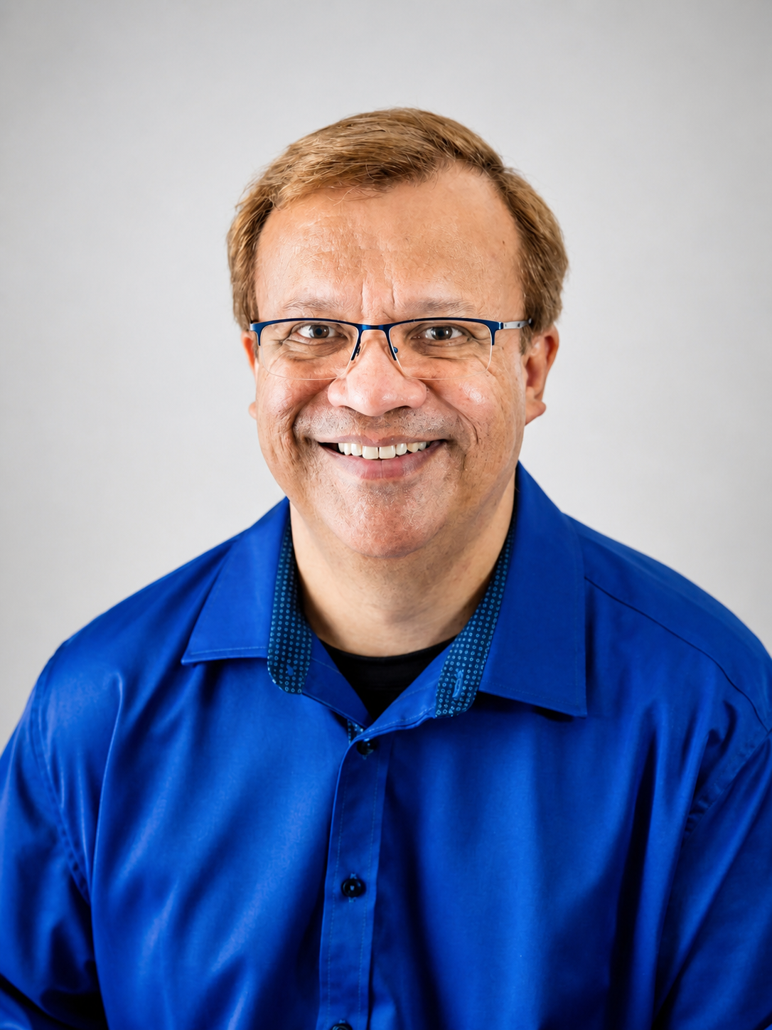Rav smiling in a blue shirt